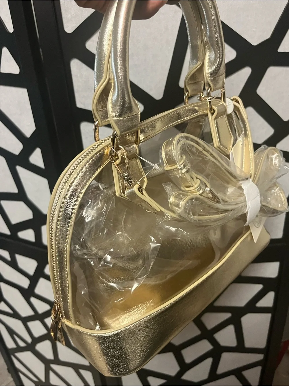 Gold clear two and one purse with handles and gold straps.